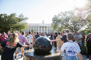 students touching globe