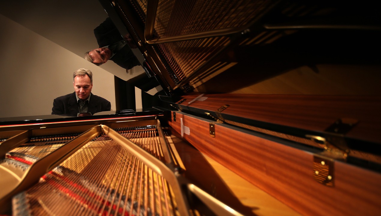piano strings and man playing