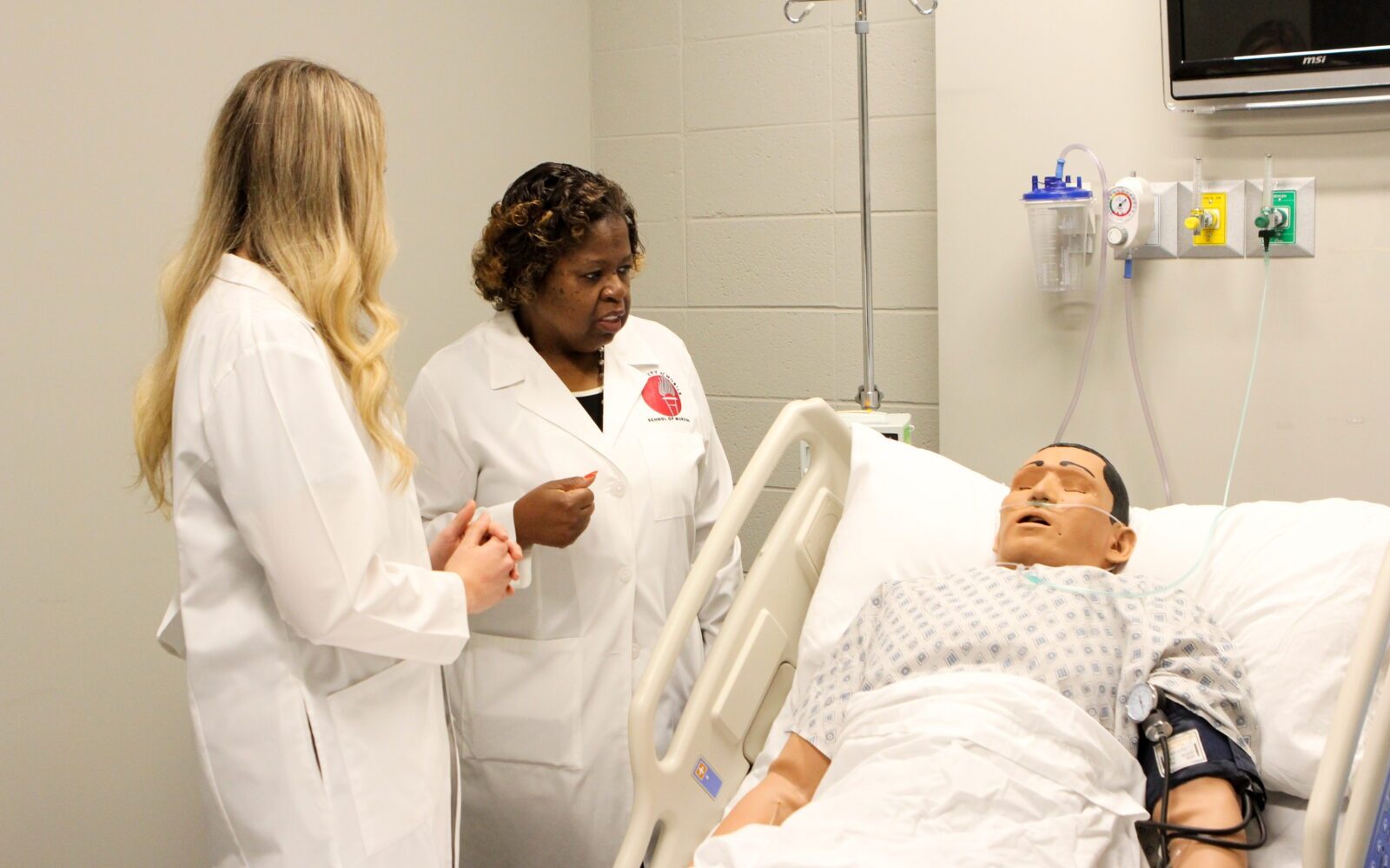 nursing students with mannequin