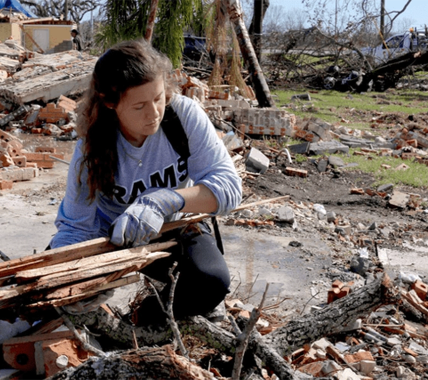 girl cleaning up debris