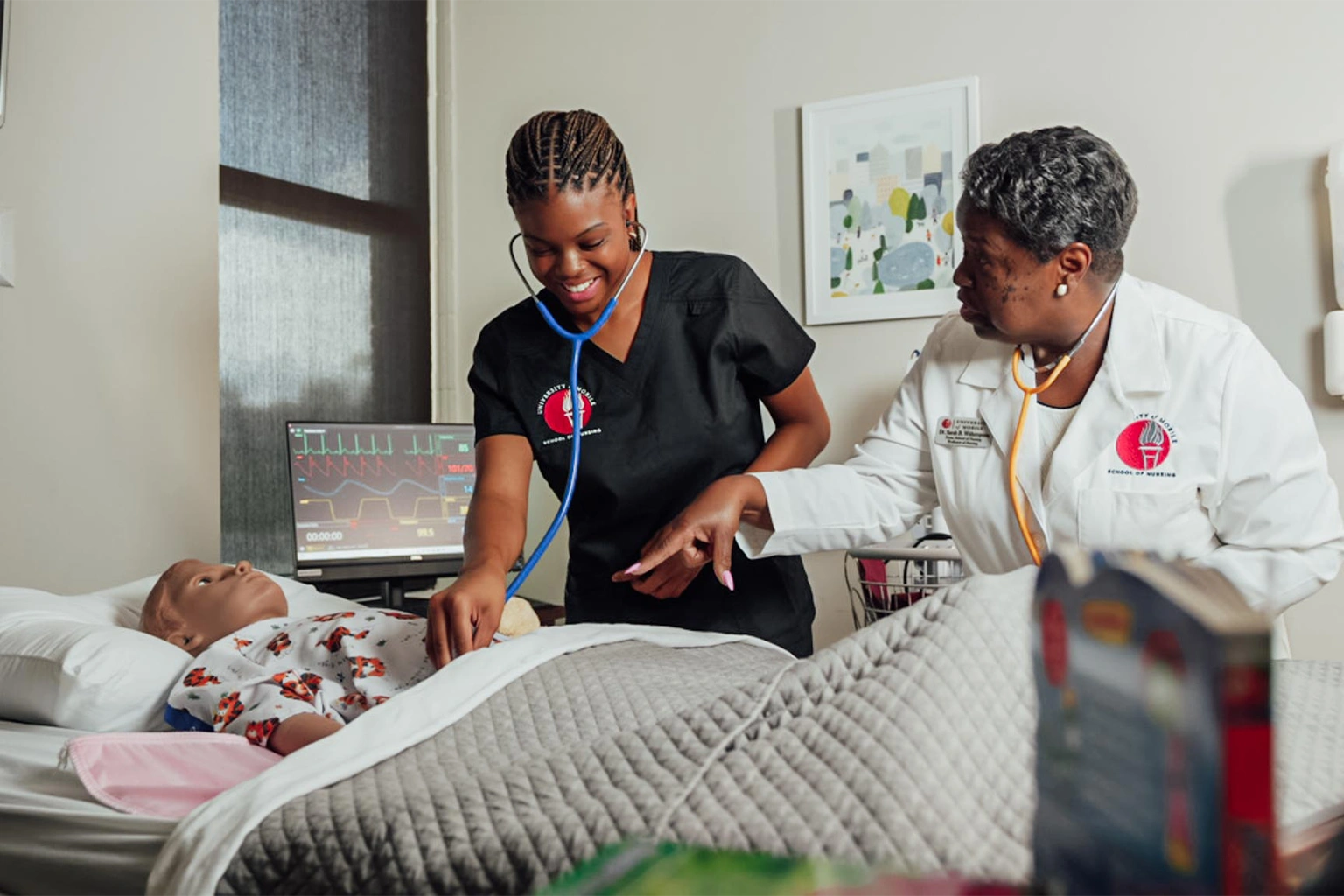 nursing student and teacher with mannequin